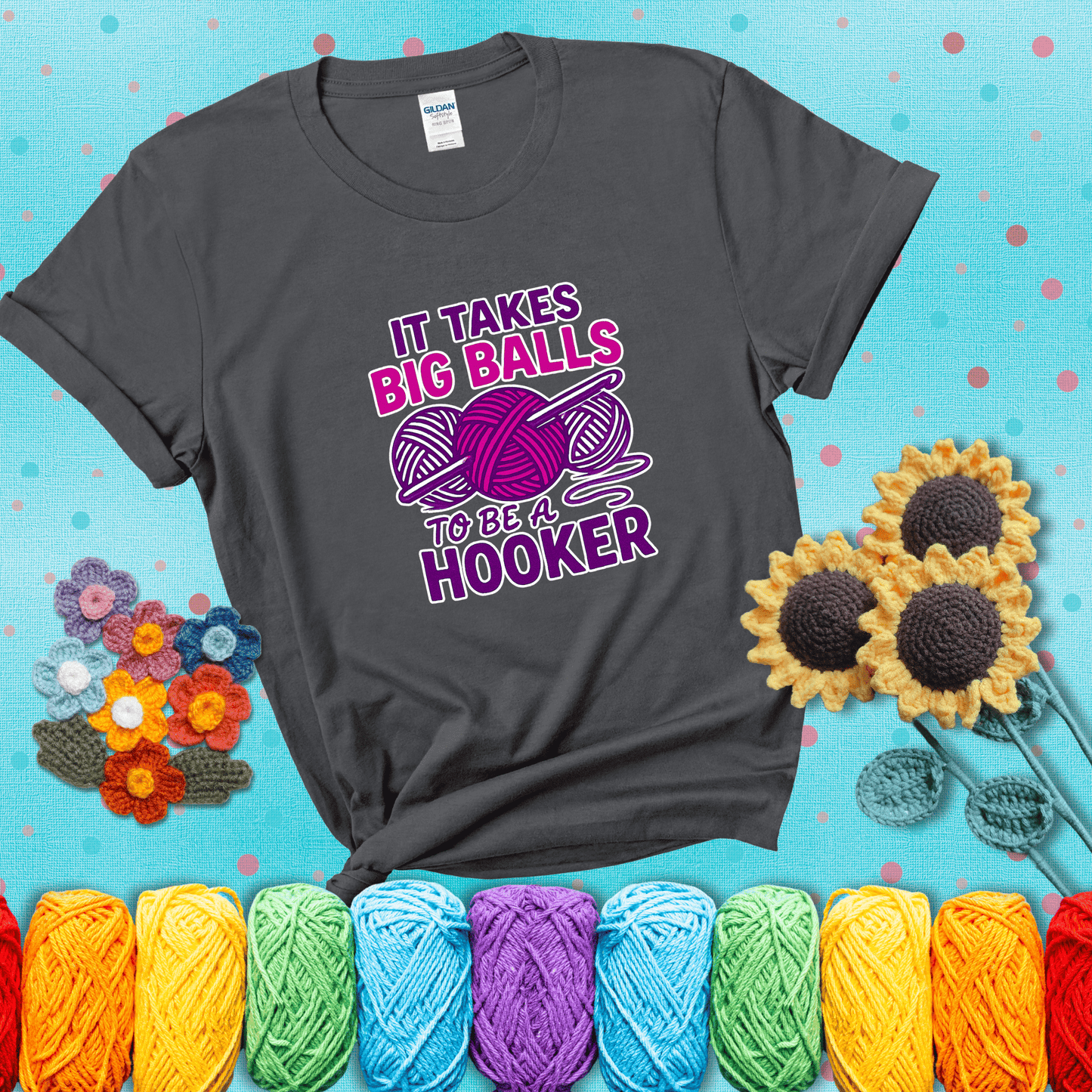 Bigger yarn, bolder energy Design reads 'It Takes Big Balls To Be A Hooker' , perfect crochet gift for yarn lovers showing a dark grey tee with a teal sunflower background