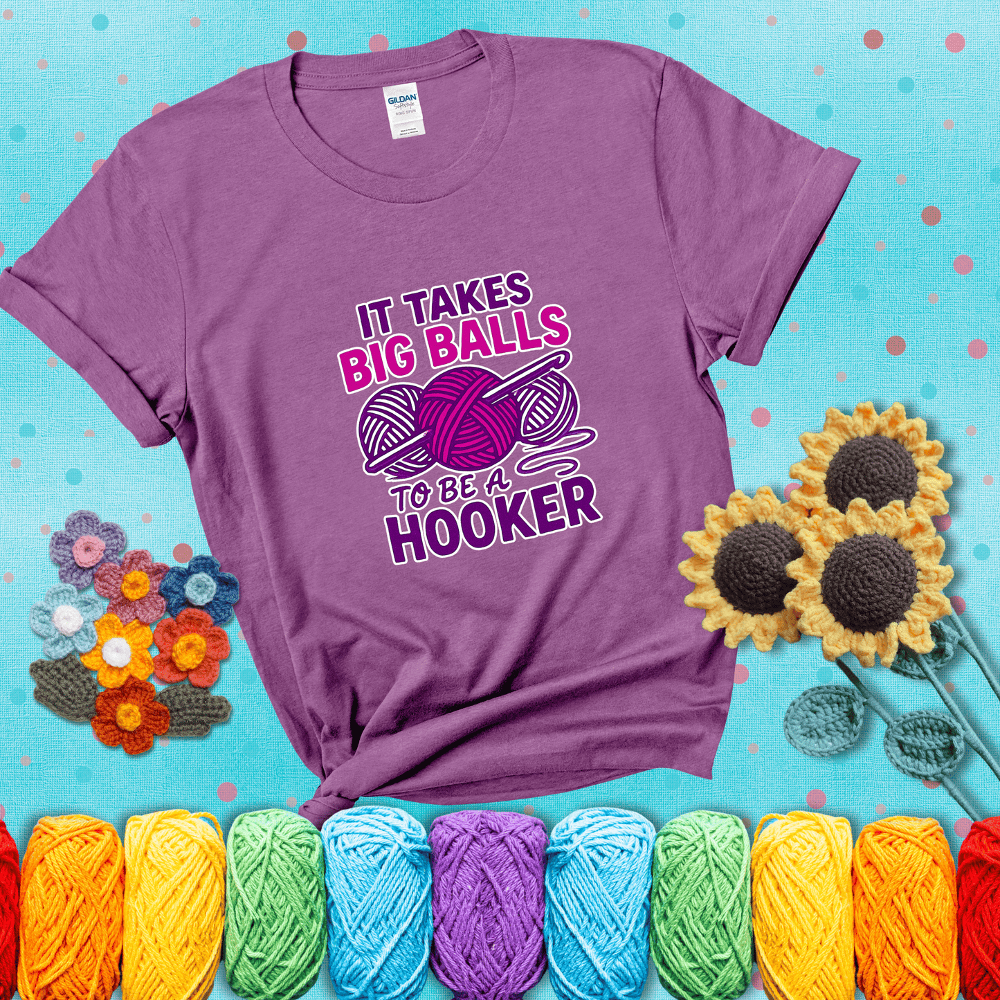 Bigger yarn, bolder energy Design reads 'It Takes Big Balls To Be A Hooker' , perfect crochet gift for yarn lovers showing a light purple tee with a teal sunflower background