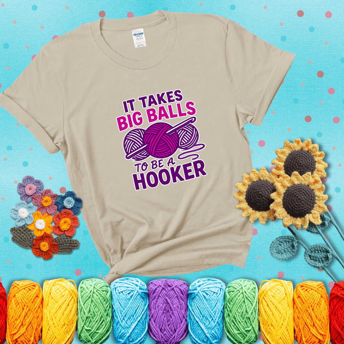 Bigger yarn, bolder energy Design reads 'It Takes Big Balls To Be A Hooker' , perfect crochet gift for yarn lovers showing a beige tee with a teal sunflower background
