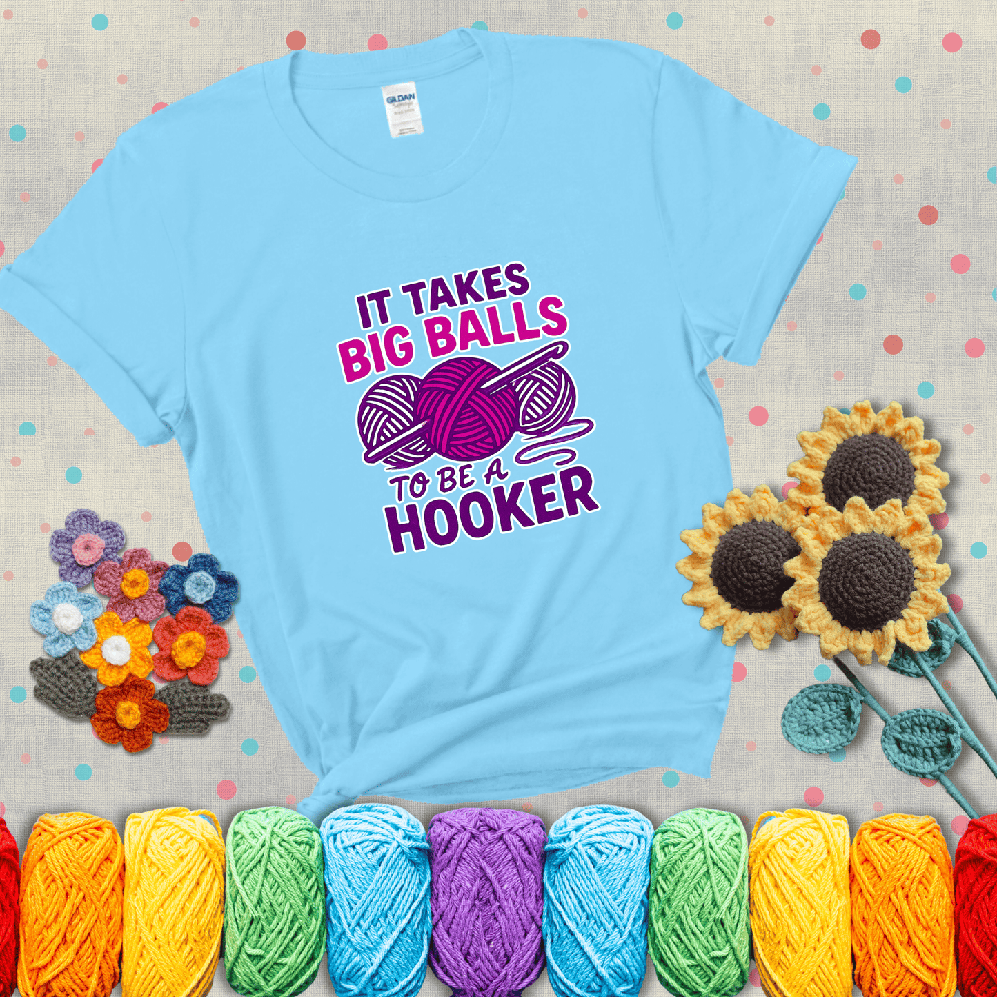 Bigger yarn, bolder energy Design reads 'It Takes Big Balls To Be A Hooker' , perfect crochet gift for yarn lovers showing a light blue tee with grey sunflower background
