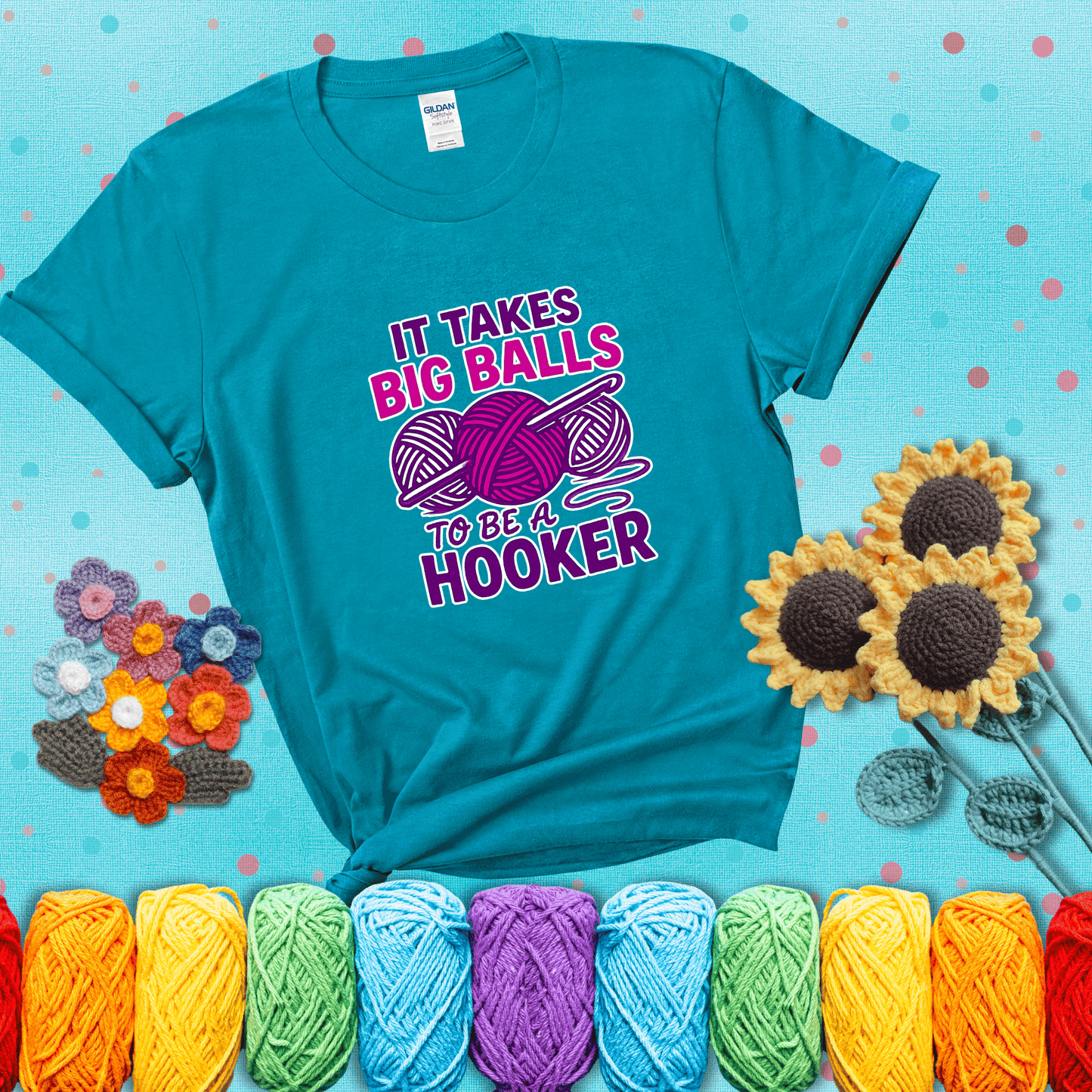 Bigger yarn, bolder energy Design reads 'It Takes Big Balls To Be A Hooker' , perfect crochet gift for yarn lovers showing a blue-green tee with a teal sunflower background