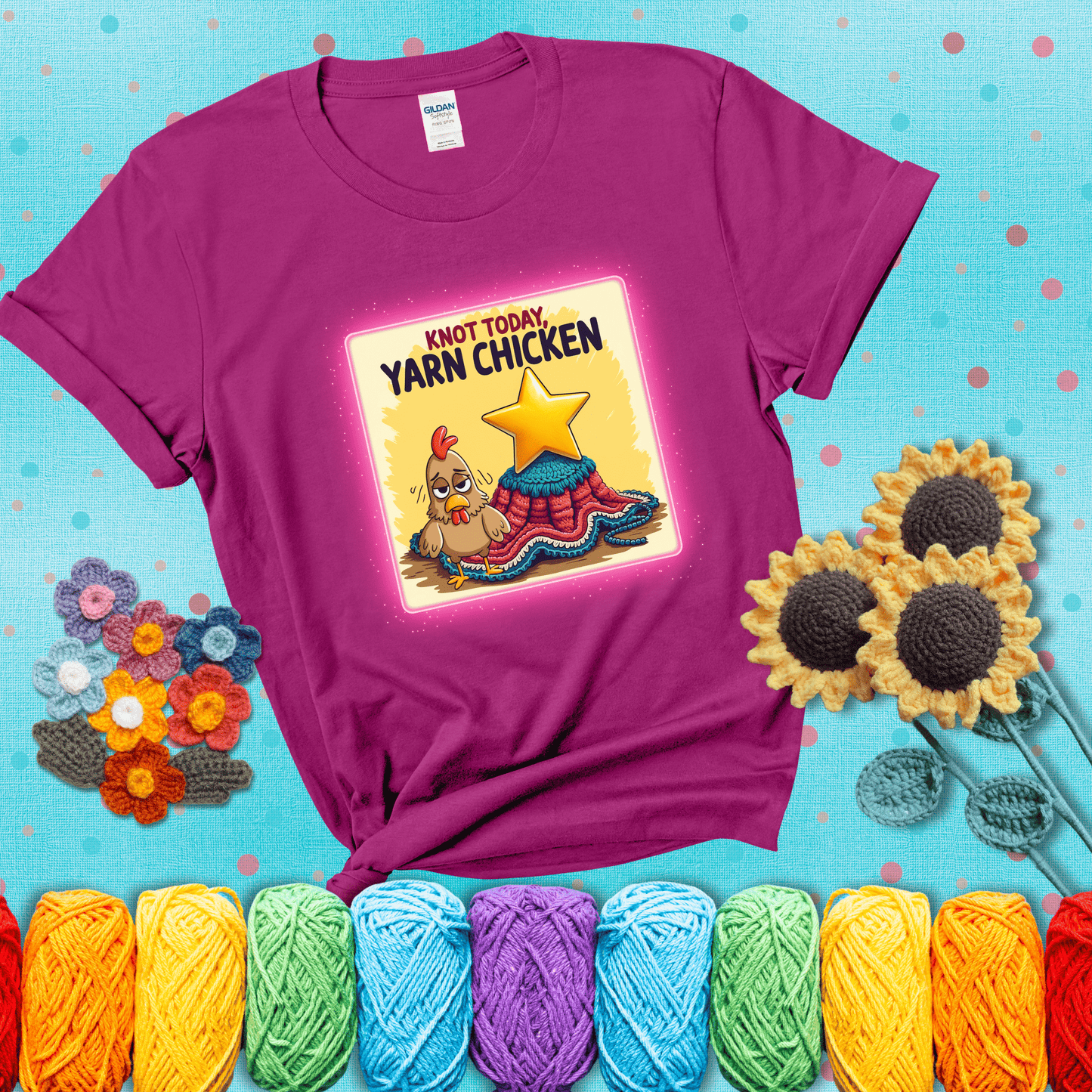 A frazzled cartoon chicken stands next to a nearly-finished project with minimal yarn left, with the phrase “Knot Today, Yarn Chicken” above, showing a magenta tee with a teal sunflower background