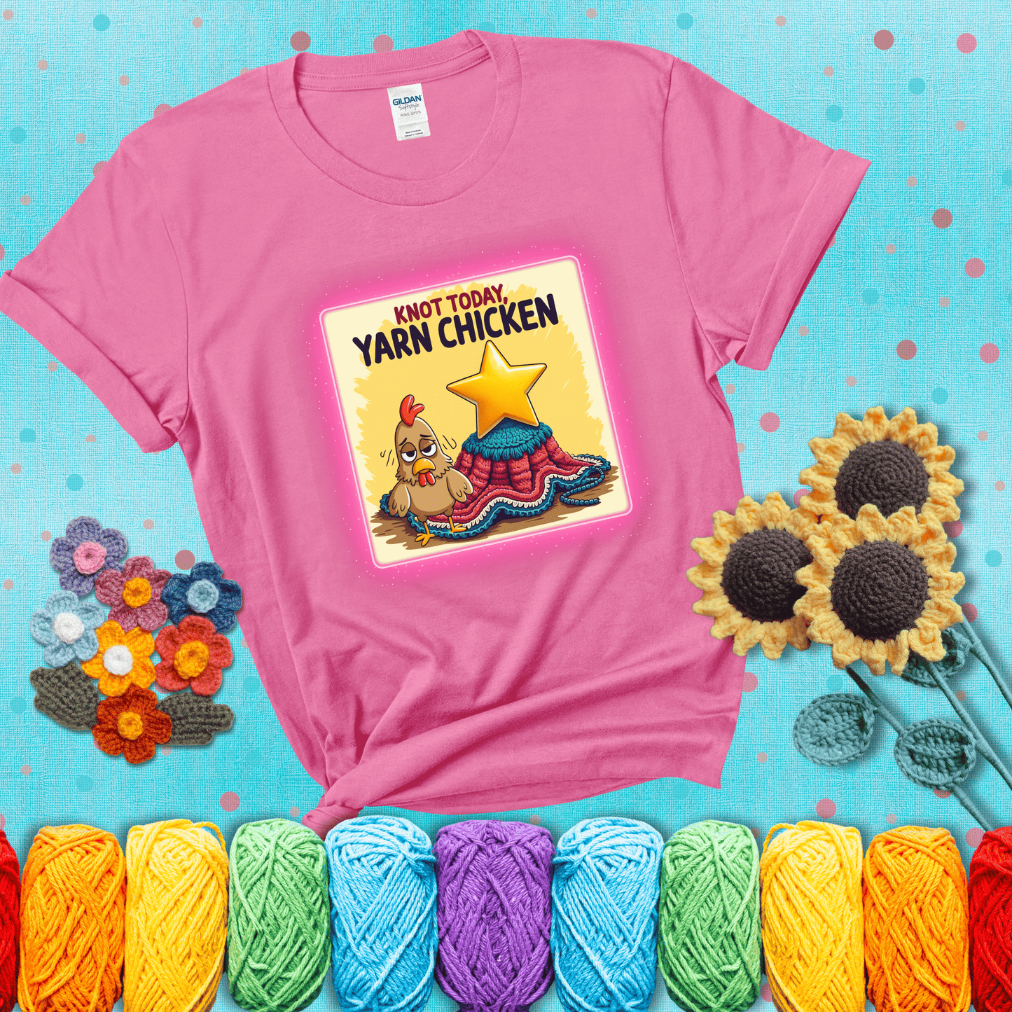 A frazzled cartoon chicken stands next to a nearly-finished project with minimal yarn left, with the phrase “Knot Today, Yarn Chicken” above, showing a pink tee with a teal sunflower background