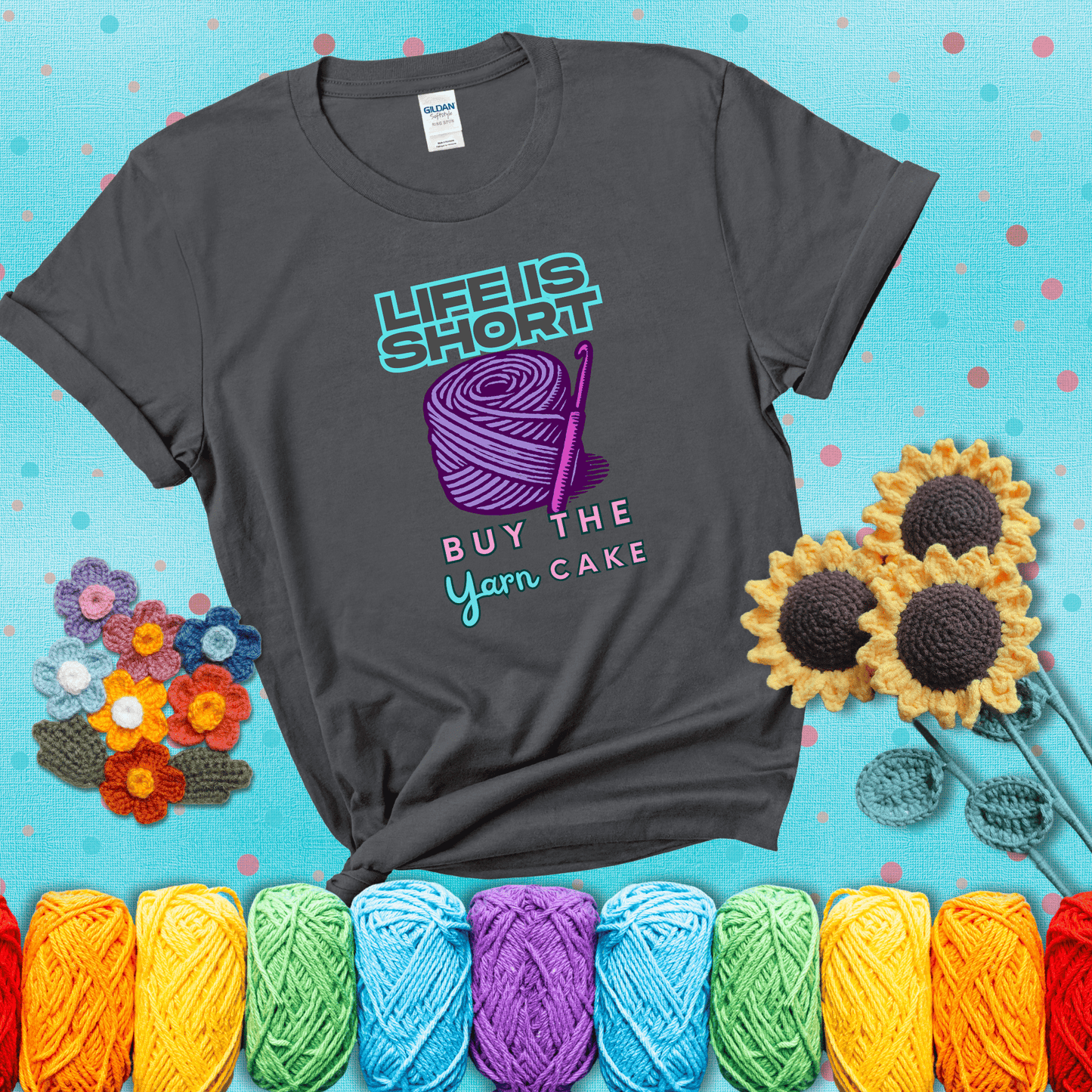 No regrets, just yarn Design reads 'Life Is Short. Buy The Yarn (Cake)' , perfect crochet gift for yarn lovers, showing a dark grey tee with a teal sunflower background