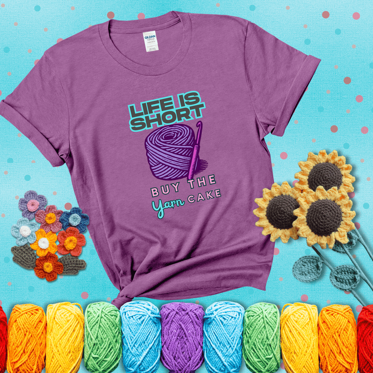 No regrets, just yarn Design reads 'Life Is Short. Buy The Yarn (Cake)' , perfect crochet gift for yarn lovers, showing a light purple tee with a teal sunflower background