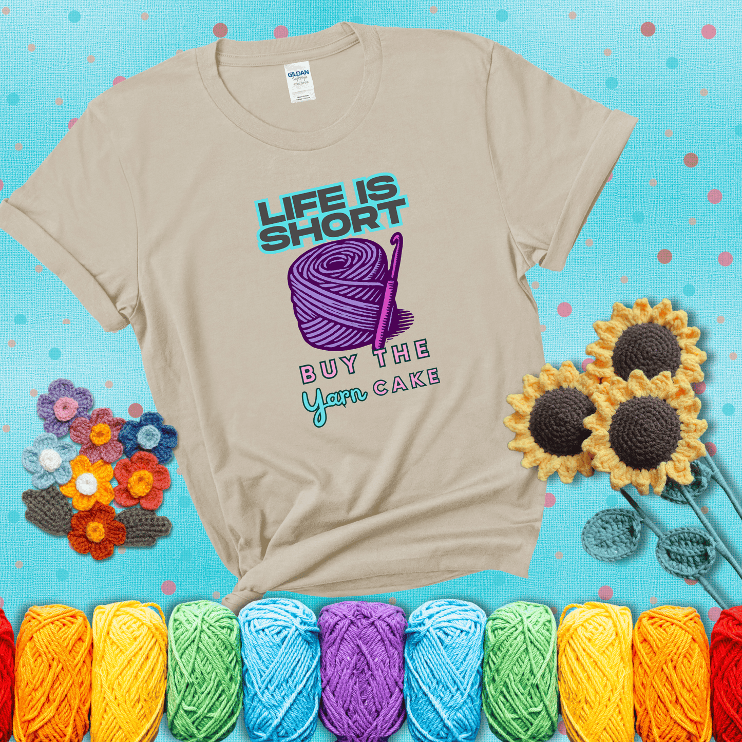 No regrets, just yarn Design reads 'Life Is Short. Buy The Yarn (Cake)' , perfect crochet gift for yarn lovers, showing a beige tee with a teal sunflower background
