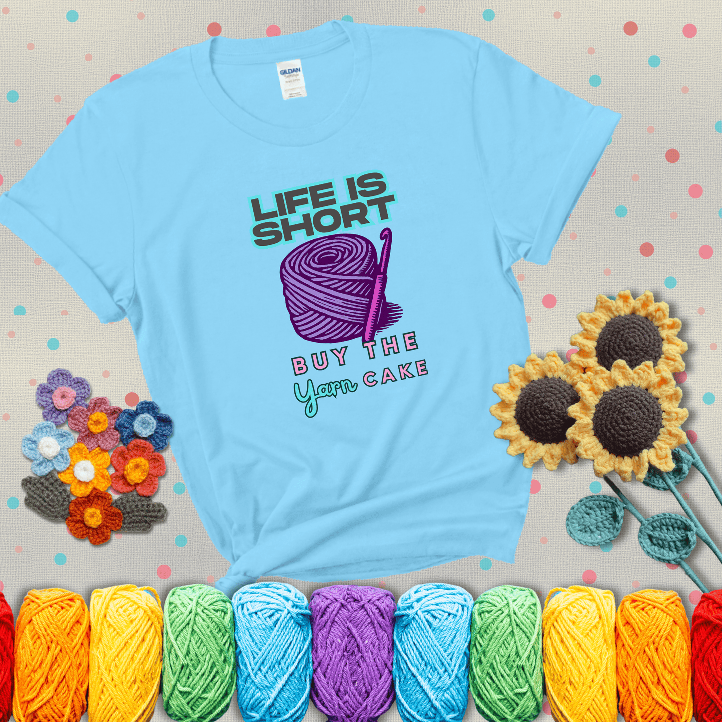 No regrets, just yarn Design reads 'Life Is Short. Buy The Yarn (Cake)' , perfect crochet gift for yarn lovers, showing a light blue tee with grey sunflower background