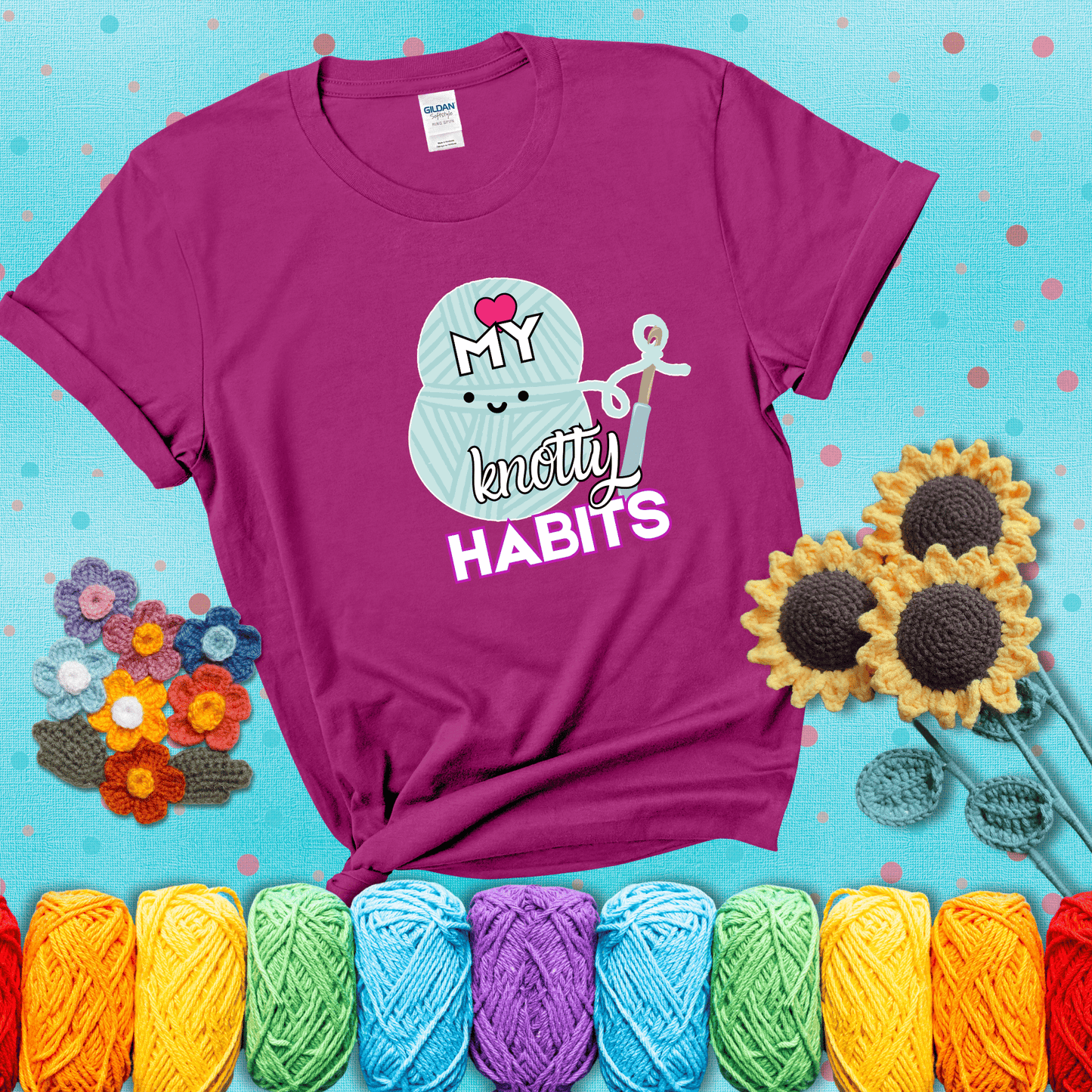 Smiling yarn ball and hook with text “Love My Knotty Habits” - cute crochet shirt with playful design for makers, showing a magenta tee with a teal sunflower background