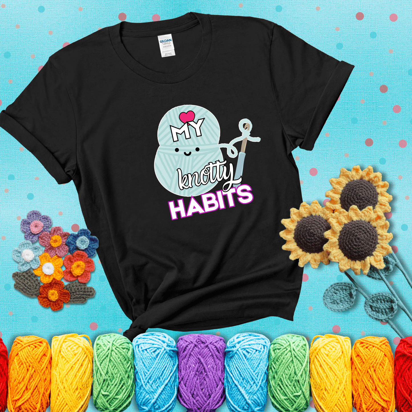 Smiling yarn ball and hook with text “Love My Knotty Habits” - cute crochet shirt with playful design for makers, showing a black tee with a teal sunflower background