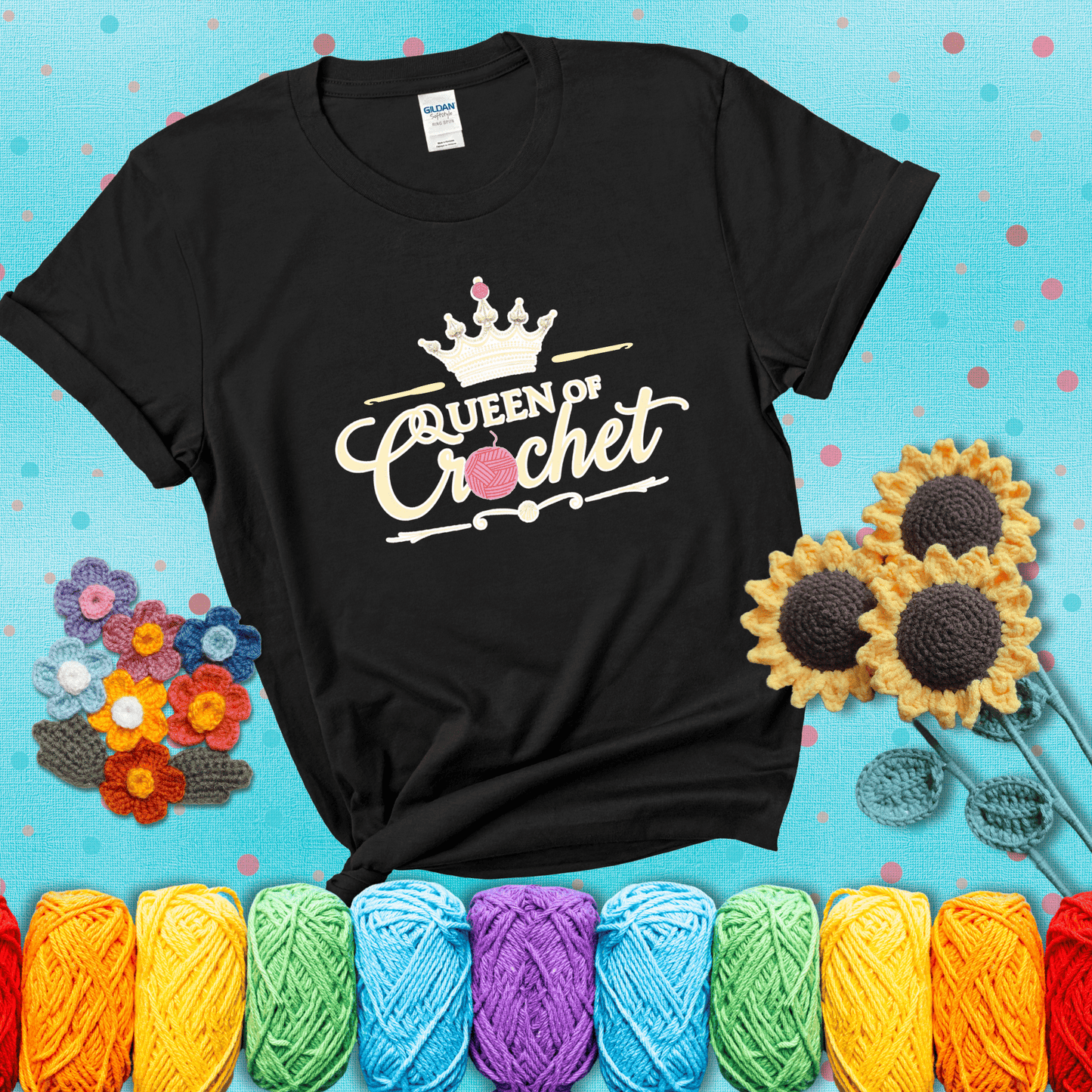 Crown-topped design reads “Queen of Crochet” with elegant script and two pink yarn balls, one forming the letter “o” and another atop the crown showing a black tee with a teal sunflower background