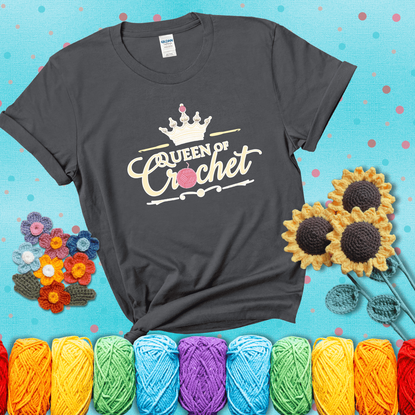 Crown-topped design reads “Queen of Crochet” with elegant script and two pink yarn balls, one forming the letter “o” and another atop the crown showing a dark grey tee with a teal sunflower background