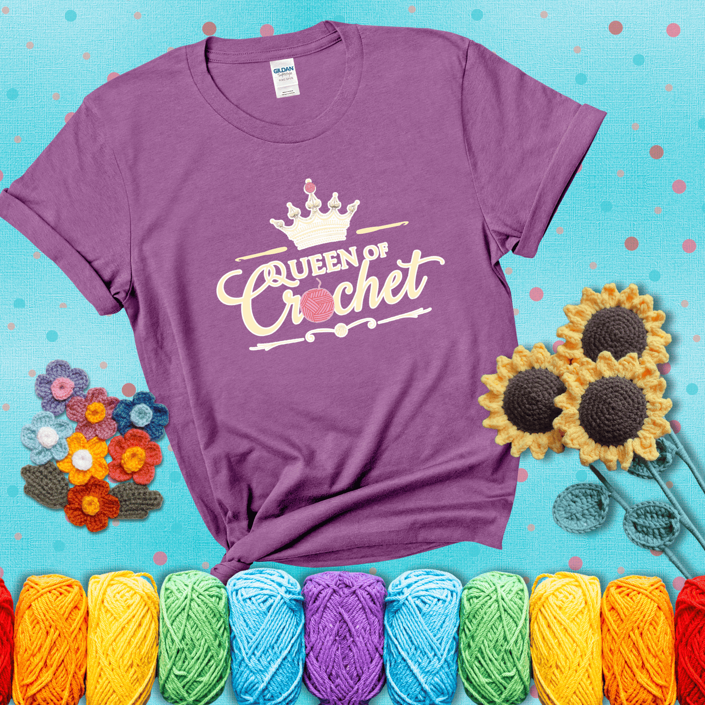 Crown-topped design reads “Queen of Crochet” with elegant script and two pink yarn balls, one forming the letter “o” and another atop the crown showing a light purple tee with a teal sunflower background