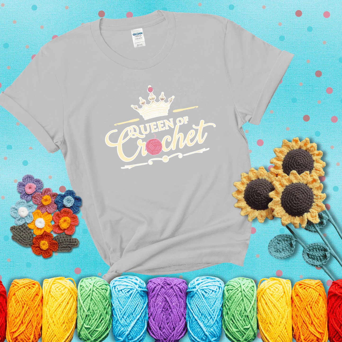 Crown-topped design reads “Queen of Crochet” with elegant script and two pink yarn balls, one forming the letter “o” and another atop the crown showing a light grey tee with a teal sunflower background