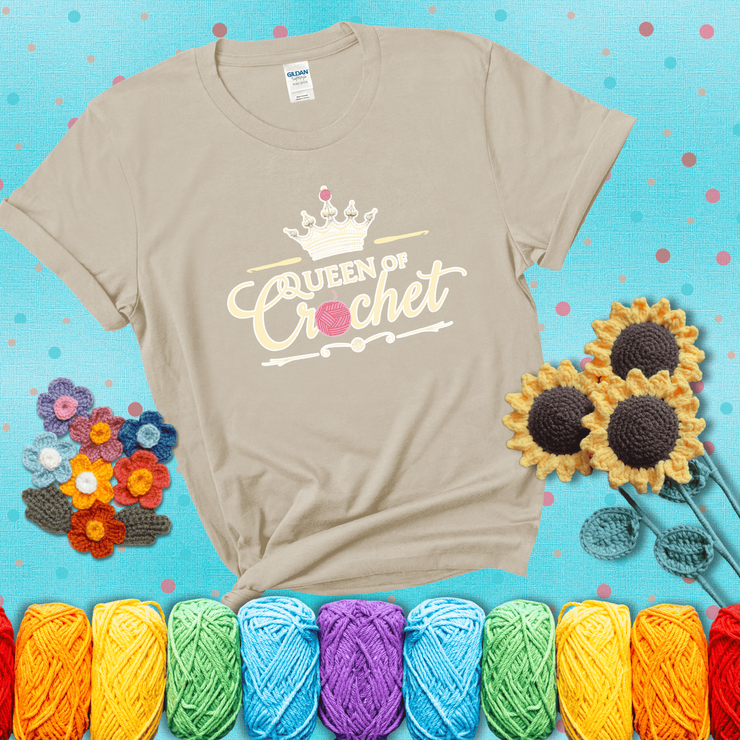 Crown-topped design reads “Queen of Crochet” with elegant script and two pink yarn balls, one forming the letter “o” and another atop the crown showing a beige tee with a teal sunflower background