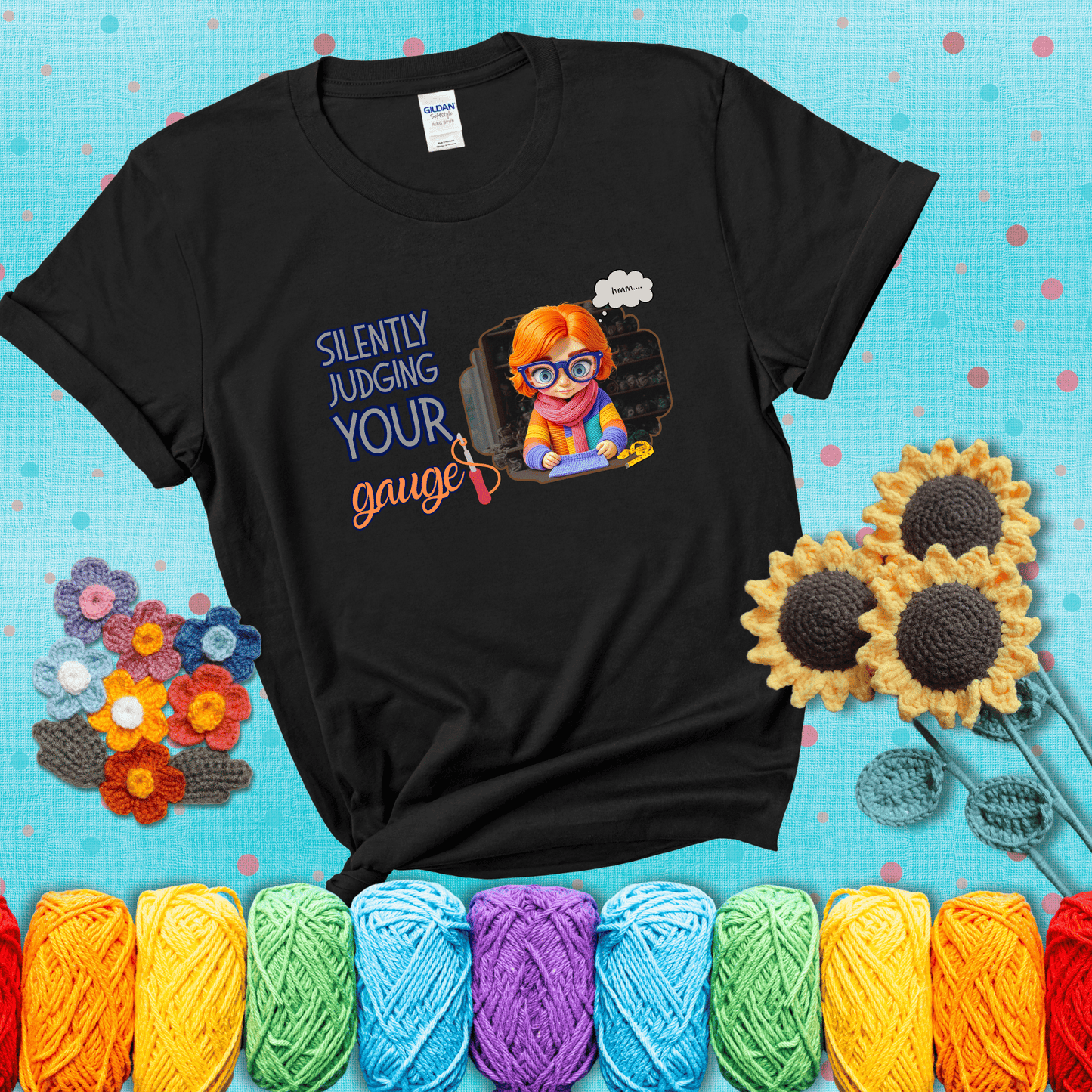 A serious-looking crocheter with rainbow clothes, big glasses, and a tape measure silently examines their stitches under the phrase “Silently judging your gauge” showing a black tee with a teal sunflower background