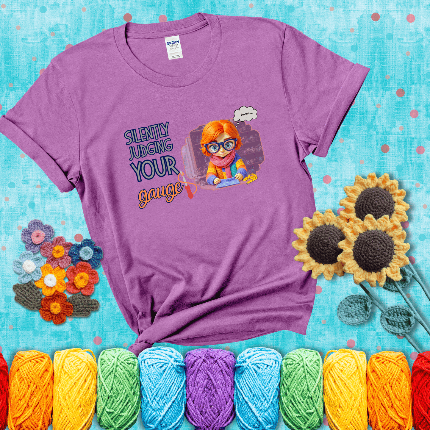 A serious-looking crocheter with rainbow clothes, big glasses, and a tape measure silently examines their stitches under the phrase “Silently judging your gauge” showing a light purple tee with a teal sunflower background