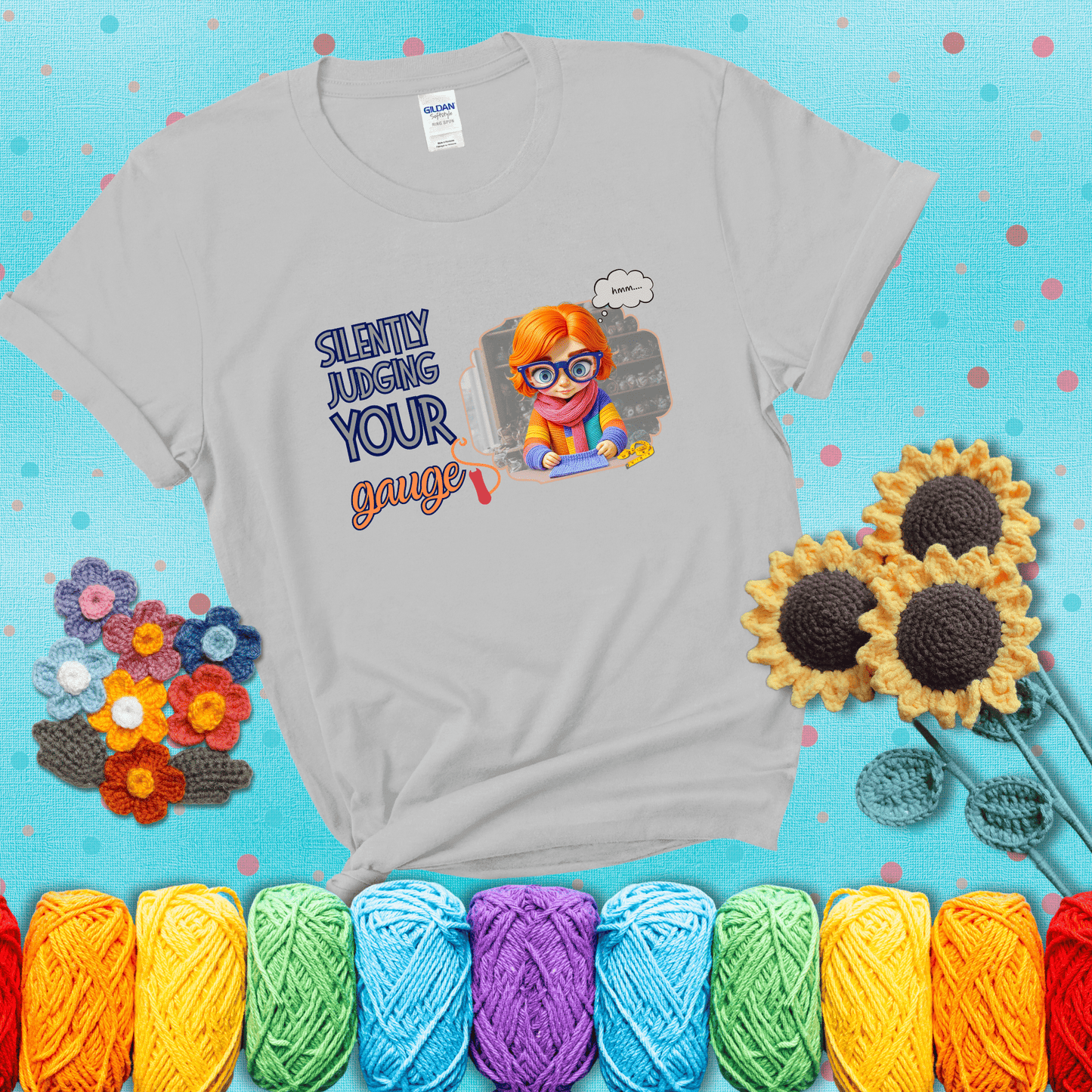 A serious-looking crocheter with rainbow clothes, big glasses, and a tape measure silently examines their stitches under the phrase “Silently judging your gauge” showing a light grey tee with a teal sunflower background