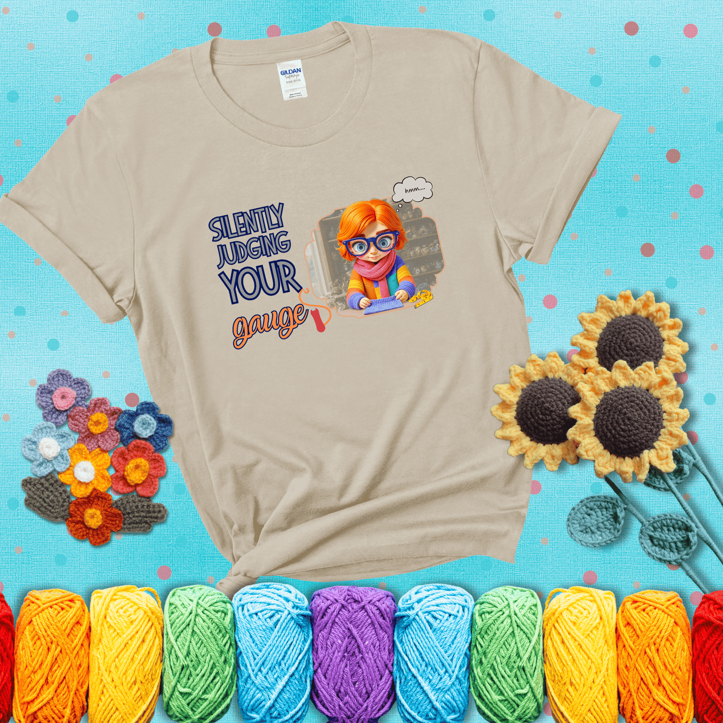 A serious-looking crocheter with rainbow clothes, big glasses, and a tape measure silently examines their stitches under the phrase “Silently judging your gauge” showing a beige tee with a teal sunflower background