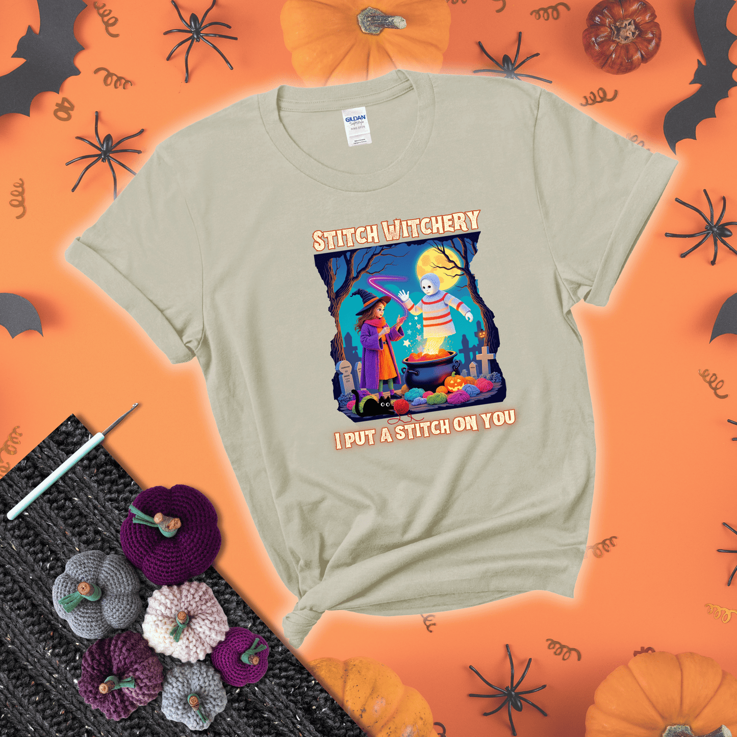 A Halloween scene with a young witch casting a yarn spell from a cauldron onto a floating crochet-ghost figure, under the phrase “I Put a Stitch on You” showing a beige tee with a festive Halloween background