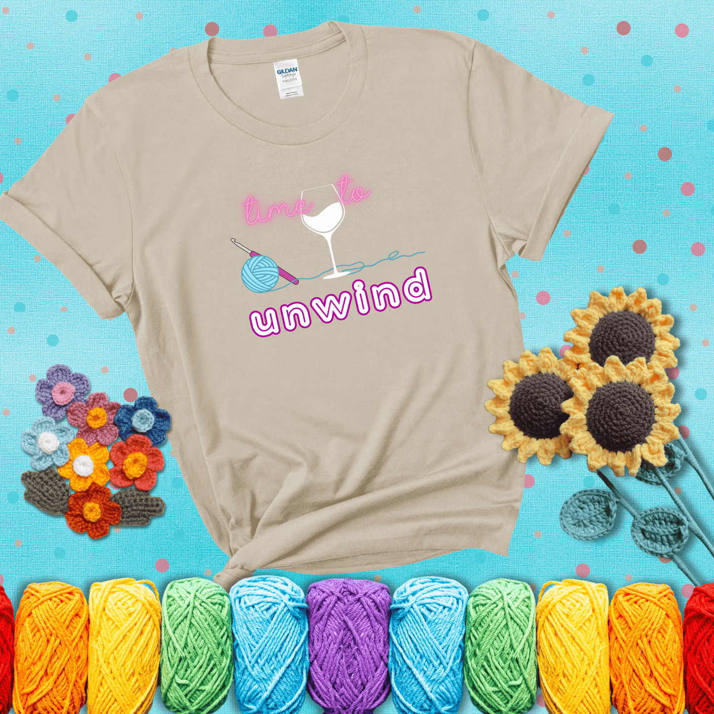 Wine down with your yarn out Design reads 'Time To Unwind' , perfect crochet gift for yarn lovers showing a beige tee with a teal sunflower background