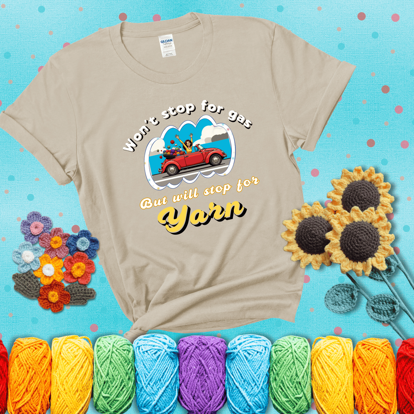 Woman joyfully driving a red convertible overflowing with yarn balls, paired with bold retro lettering and a playful slogan showing a beige tee with a teal sunflower background
