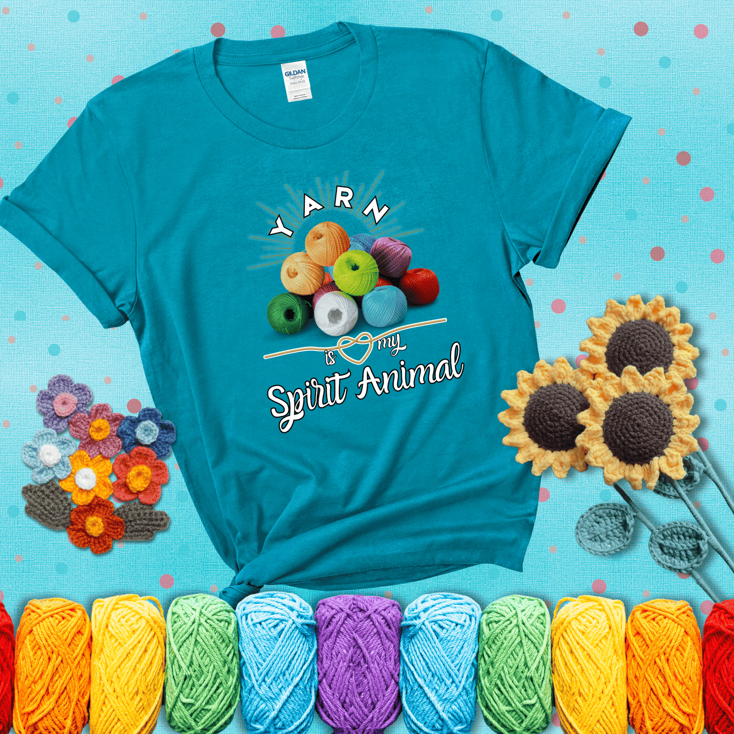Stack of colorful yarn balls with radiant glow. Text reads: “Yarn Is My Spirit Animal.” A calming and colorful tee for fiber lovers who find zen in stitching, showing a blue-green tee with a teal sunflower background