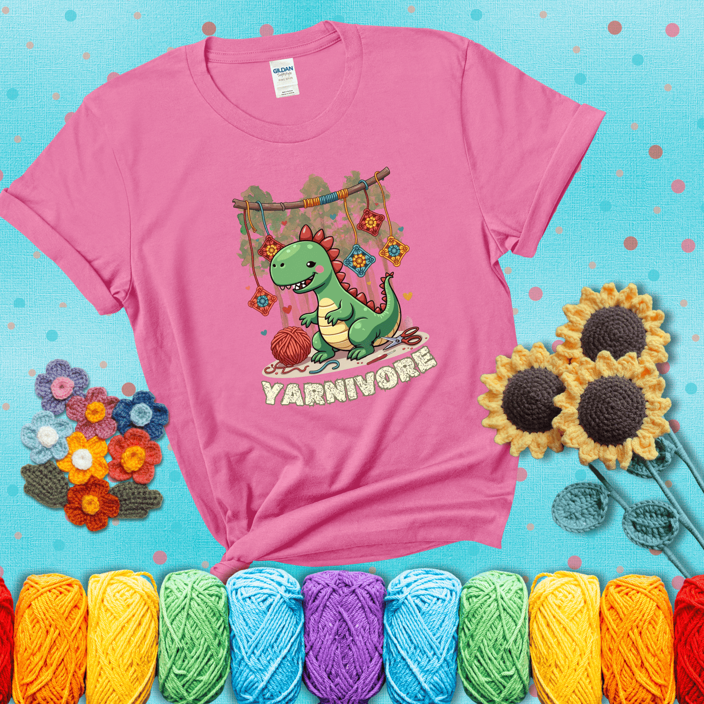 Silly dinosaur chomping on yarn skeins. Text reads: “Yarnivore.” A fun and quirky tee for yarn-obsessed crafters with big appetites, showing a pink tee with a teal sunflower background