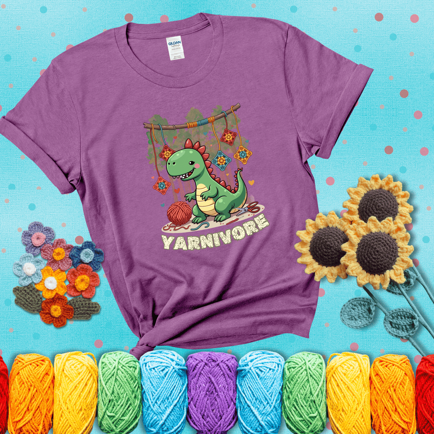 Silly dinosaur chomping on yarn skeins. Text reads: “Yarnivore.” A fun and quirky tee for yarn-obsessed crafters with big appetites, showing a light purple tee with a teal sunflower background
