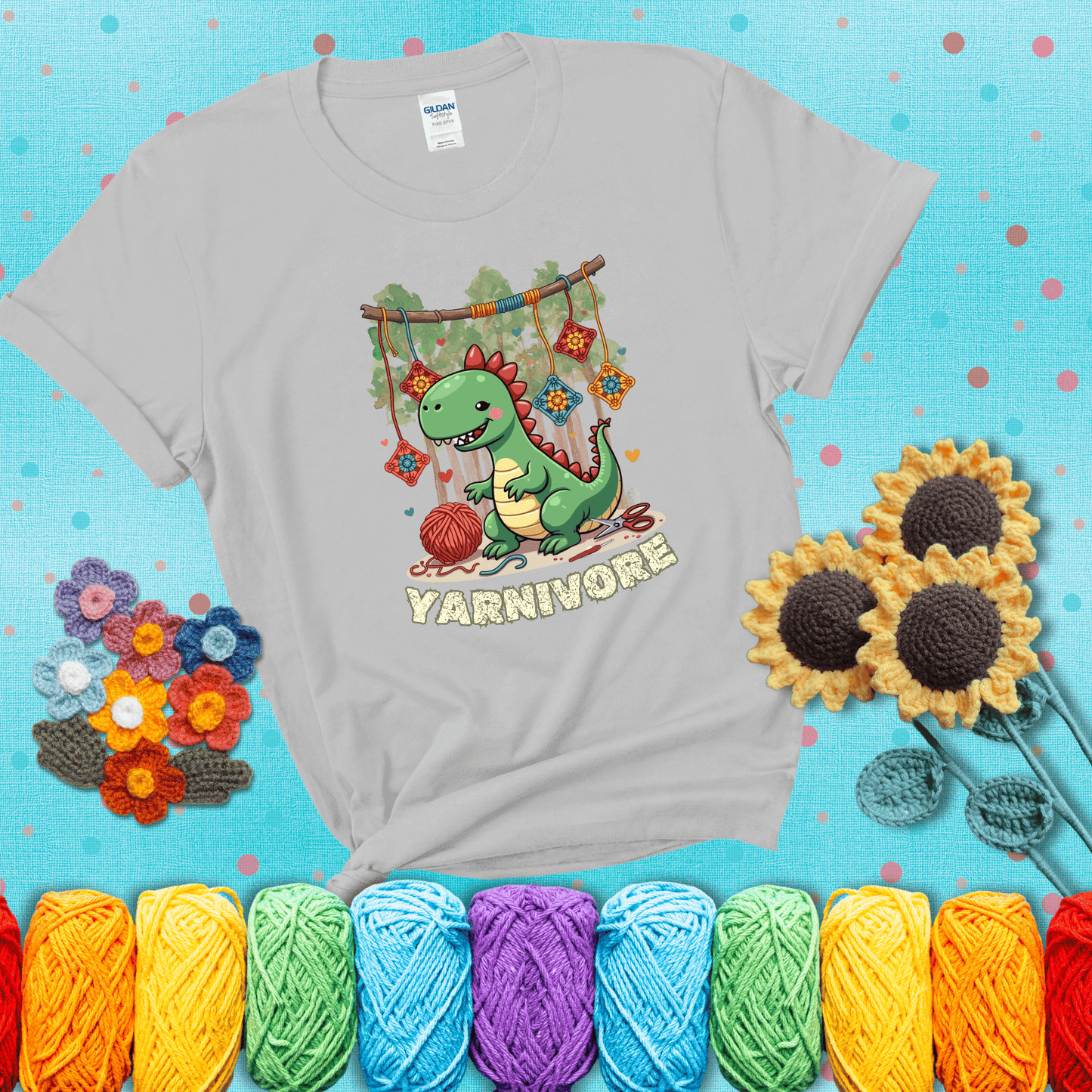 Silly dinosaur chomping on yarn skeins. Text reads: “Yarnivore.” A fun and quirky tee for yarn-obsessed crafters with big appetites, showing a light grey tee with a teal sunflower background