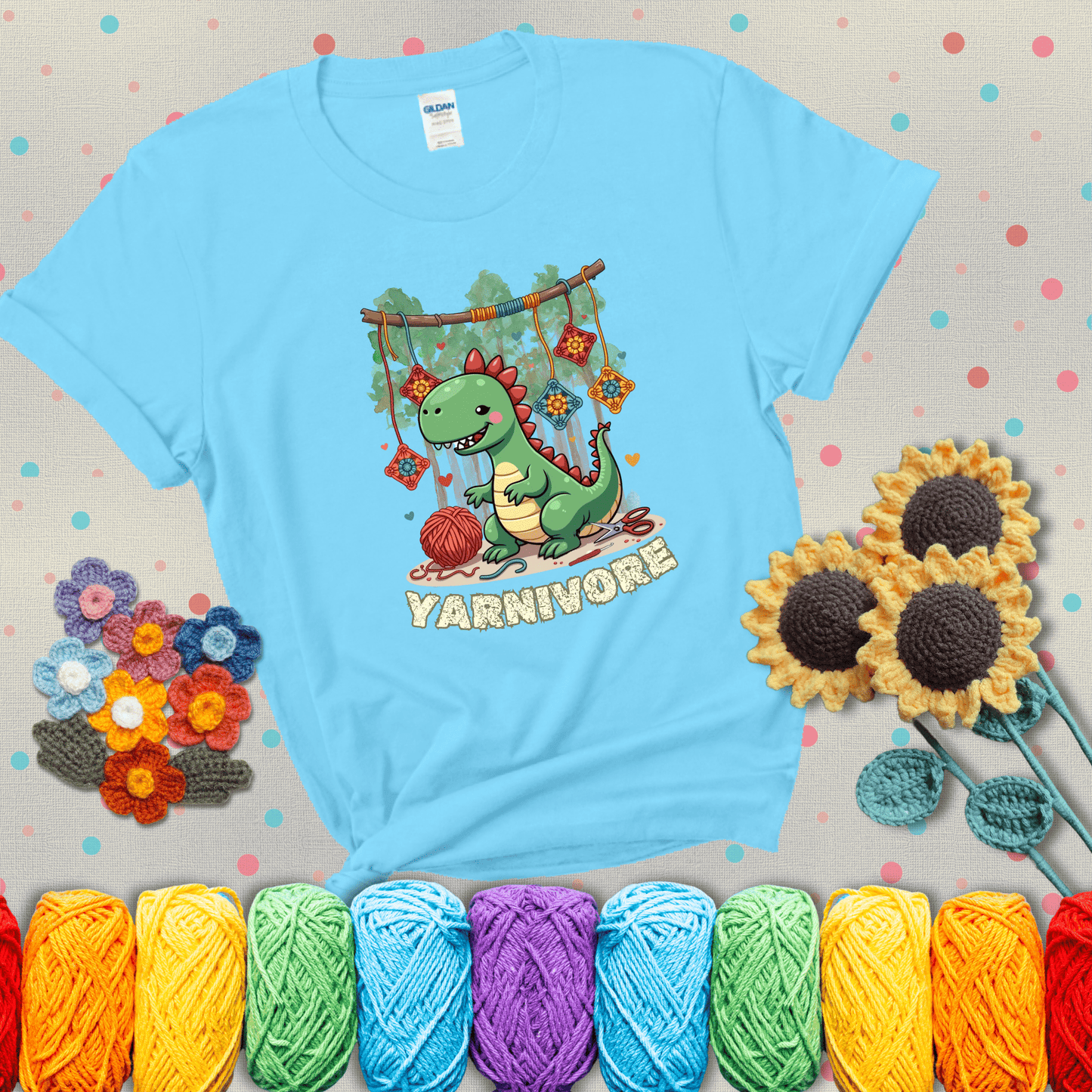Silly dinosaur chomping on yarn skeins. Text reads: “Yarnivore.” A fun and quirky tee for yarn-obsessed crafters with big appetites, showing a light blue tee with grey sunflower background
