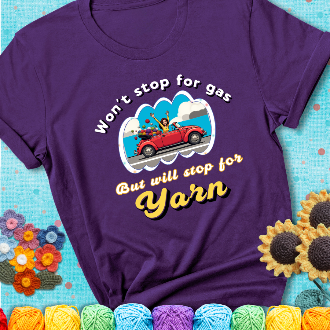 Purple t-shirt with a woman driving a red convertible filled with yarn and the phrase “Won't Stop For Gas But Will Stop For Yarn.”
