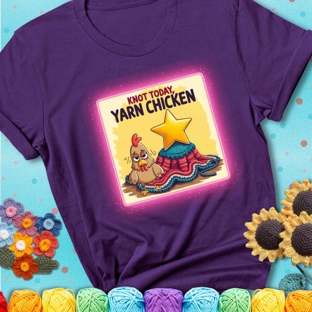 A purple t-shirt showing a frazzled cartoon chicken stands next to a nearly-finished project with minimal yarn left, with the phrase “Knot Today, Yarn Chicken” above.