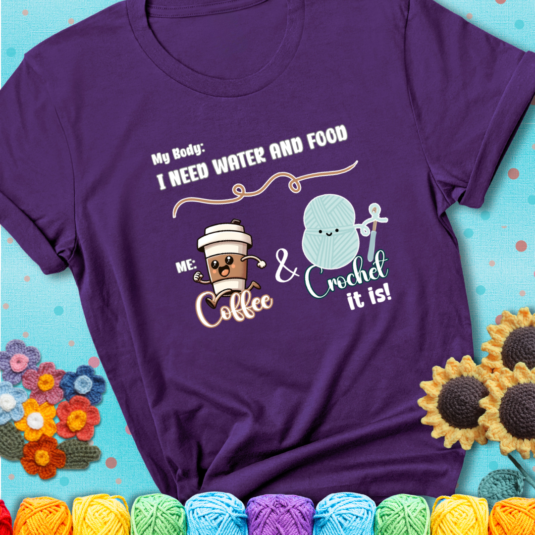 Design reads “My body: I need water and food. Me: Coffee & Crochet it is,” with a smiling coffee cup and yarn ball characters on a purple t-shirt.