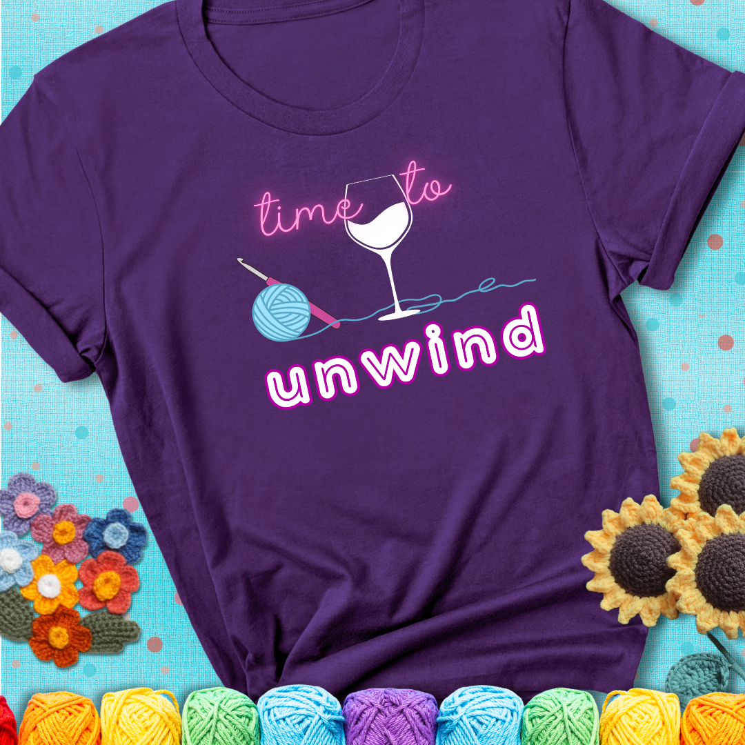 Wine down with your yarn out Design reads 'Time To Unwind' , perfect crochet gift for yarn lovers showing a purple tee with a teal sunflower background