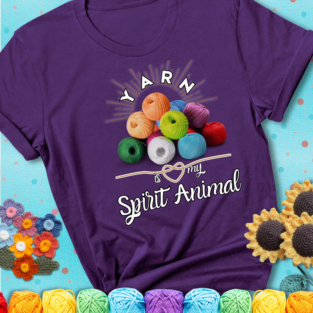 Stack of colorful yarn balls with radiant glow. Text reads: “Yarn Is My Spirit Animal.” A calming and colorful tee for fiber lovers who find zen in stitching, showing a purple tee with a teal sunflower background