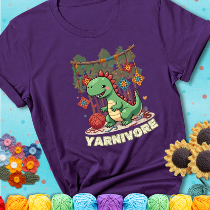 Purple t-shirt shows a cute green dinosaur with yarn ball and granny squares, text “Yarnivore”, a fun crochet shirt for dino and yarn fans.