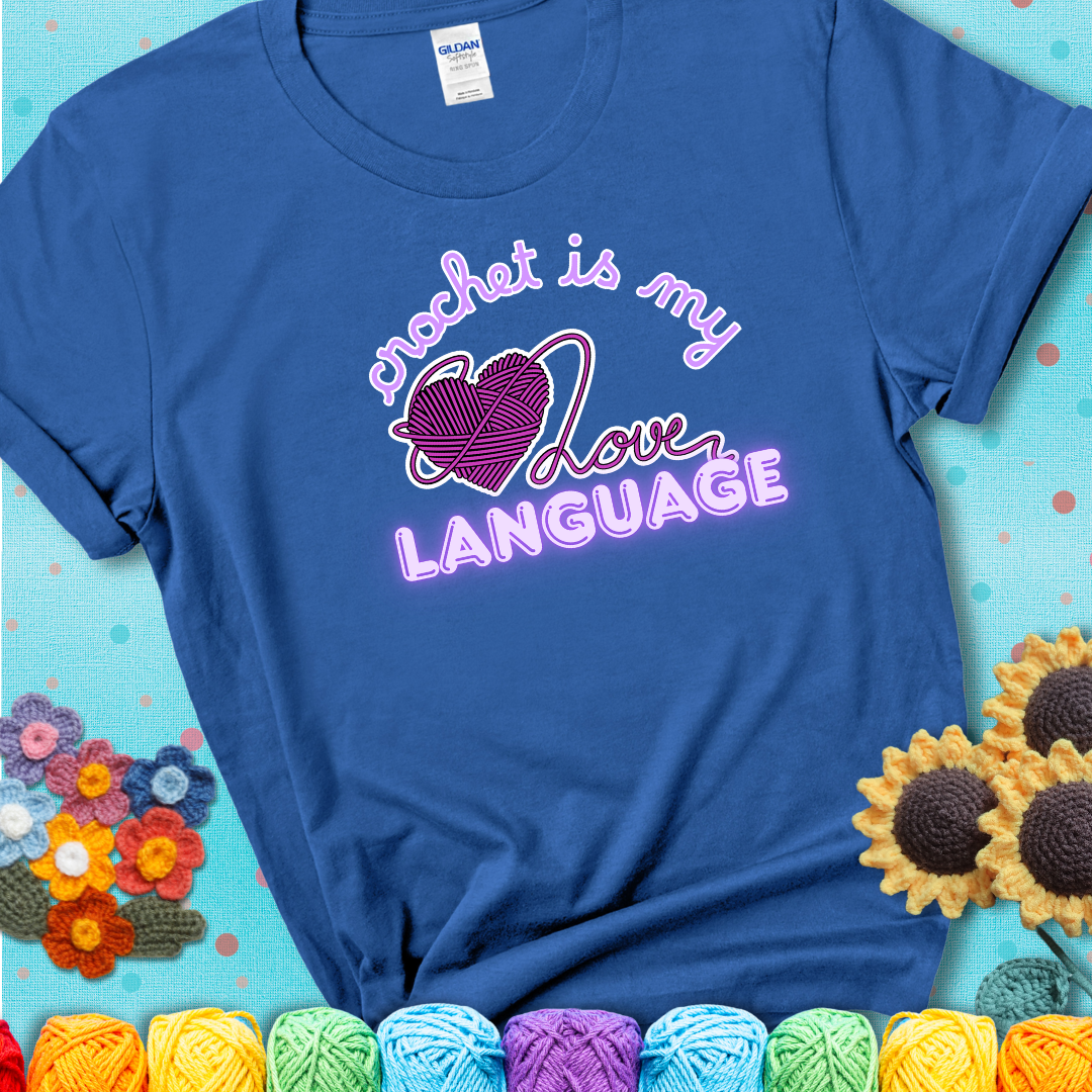 Say it with stitches Design reads 'Crochet Is My Love Language', perfect crochet gift for yarn lovers; showing a blue tee with a teal sunflower background