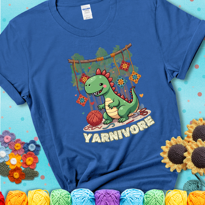 Blue t-shirt shows a cute green dinosaur with yarn ball and granny squares, text “Yarnivore”, a fun crochet shirt for dino and yarn fans.