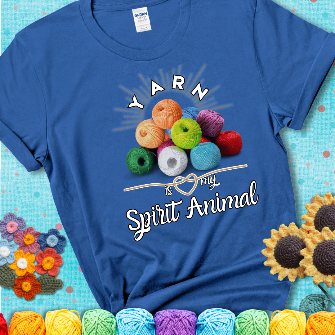 Stack of colorful yarn balls with radiant glow. Text reads: “Yarn Is My Spirit Animal.” A calming and colorful tee for fiber lovers who find zen in stitching, showing a blue tee with a teal sunflower background