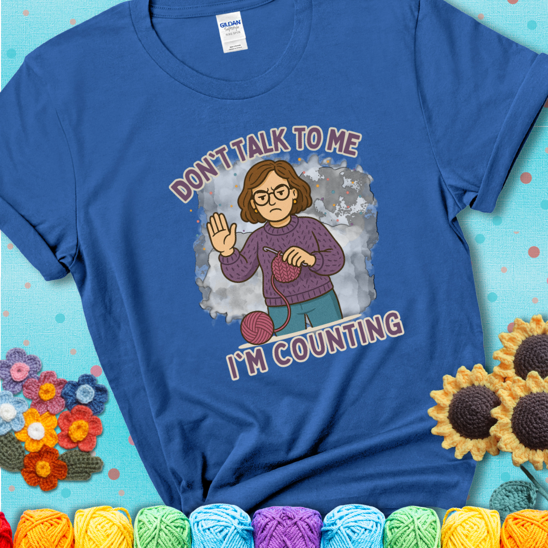 Royal blue t-shirt with an annoyed maker holding up a hand beside yarn, with the phrase “Don’t Talk To Me, I’m Counting.”