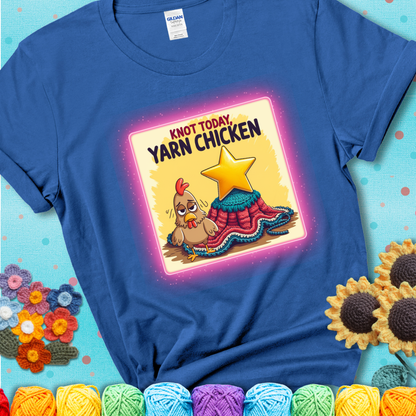 A blue t-shirt showing a frazzled cartoon chicken stands next to a nearly-finished project with minimal yarn left, with the phrase “Knot Today, Yarn Chicken” above.