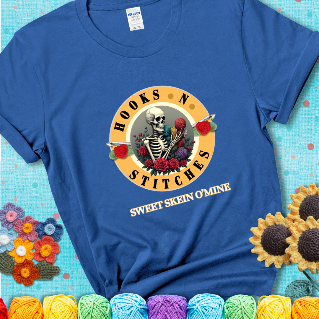 Royal Blue t-shirt with a skeleton holding colorful yarn, roses, crochet hooks, and the phrases “Hooks ’N Stitches” and “Sweet Skein O’Mine.”
