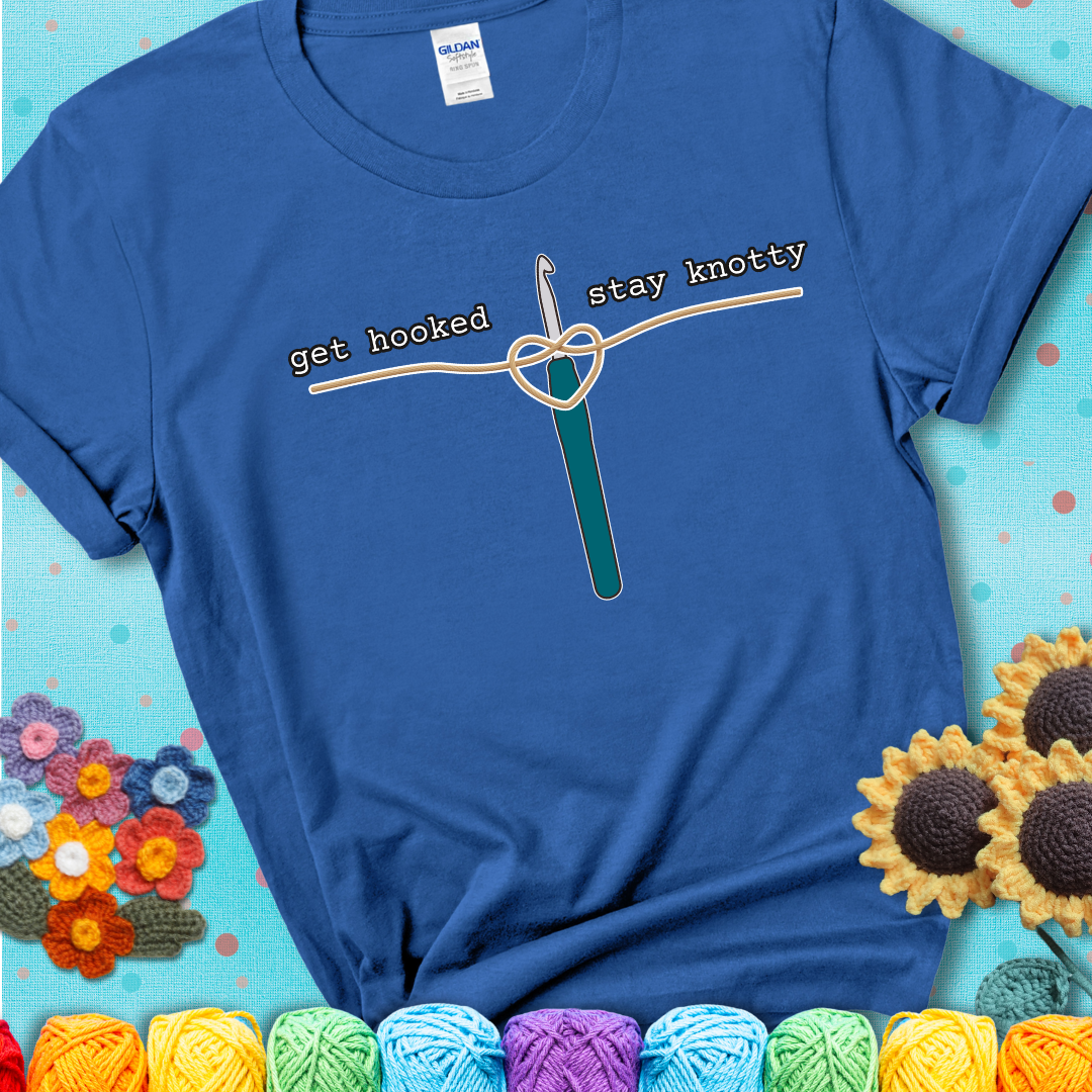 Hooked on yarn? Same Design reads 'Get Hooked, Stay Knotty' , perfect crochet gift for yarn lovers, showing a blue tee with a teal sunflower background
