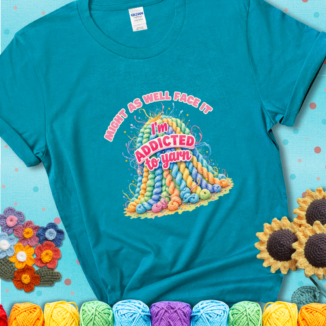 Tropical Blue t-shirt with a colorful mountain of pastel yarn hanks and the phrase “Might As Well Face It, I’m Addicted To Yarn” in pink and red lettering.
