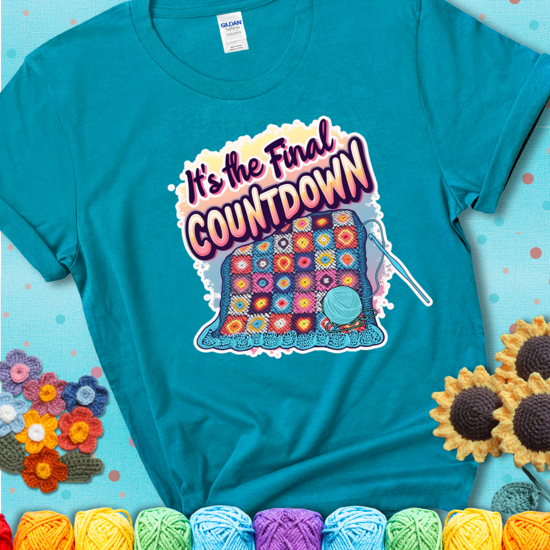 Tropical Blue t-shirt with a colorful crochet blanket in progress, blue yarn ball, crochet hook, and the phrase “It’s The Final Countdown.”