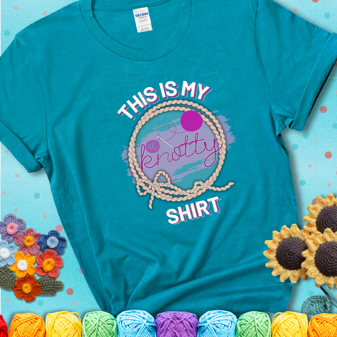Tropical Blue t-shirt with the phrase “This is My Knotty Shirt” inside a rope circle, featuring a yarn ball and crochet hook forming the word “knotty.”