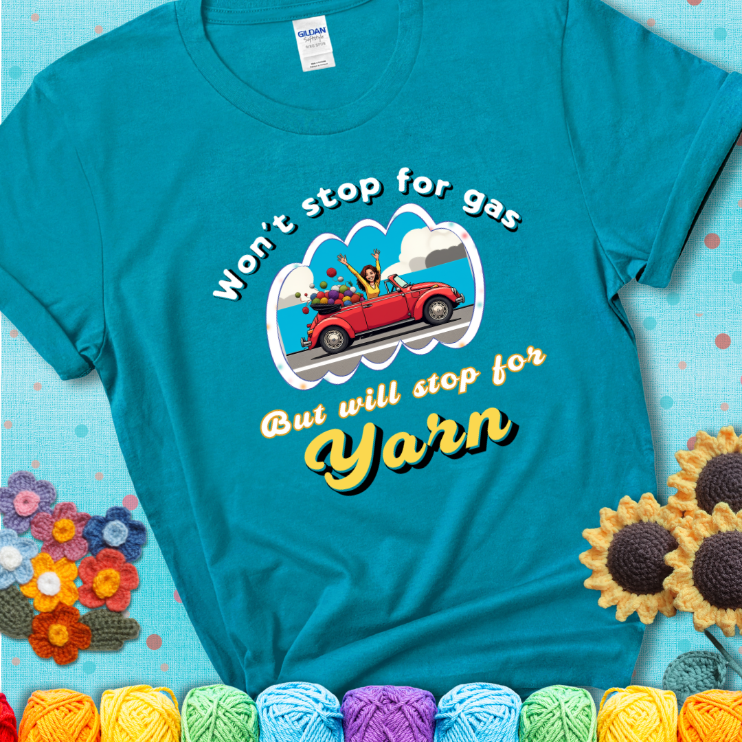 Tropical blue t-shirt with a woman driving a red convertible filled with yarn and the phrase “Won't Stop For Gas But Will Stop For Yarn.”
