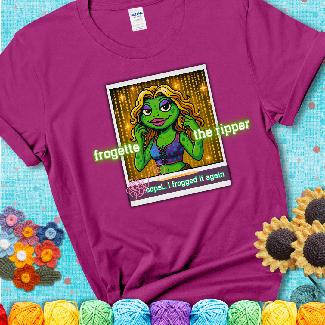 Retro-styled illustration of a glamorous green frog in a sparkly outfit, labeled "Frogette the Ripper" with the phrase “Oops! I frogged it again” below, referencing both crochet and pop culture showing a magenta tee with a teal sunflower background