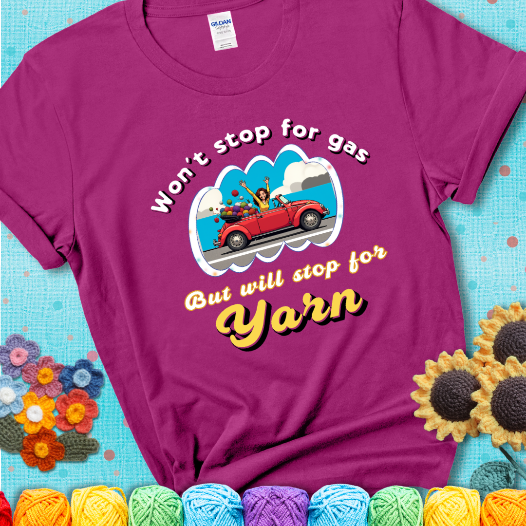 Antique Heliconia t-shirt with a woman driving a red convertible filled with yarn and the phrase “Won't Stop For Gas But Will Stop For Yarn.”