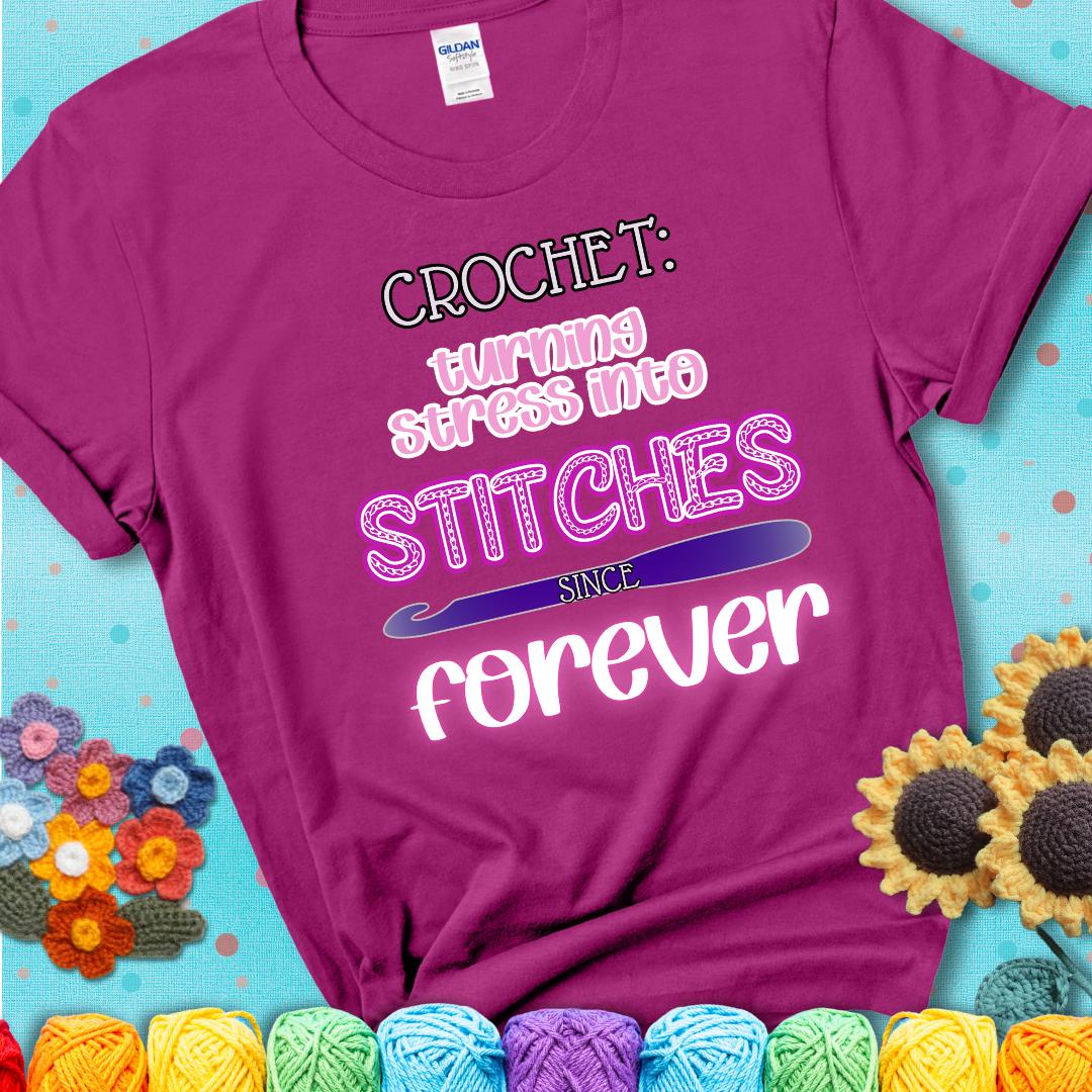 When life gets tangled, we stitch it out Design reads 'Crochet: Turning Stress Into Stitches Since Forever' , perfect crochet gift for yarn lovers; showing a magenta tee with a teal sunflower background
